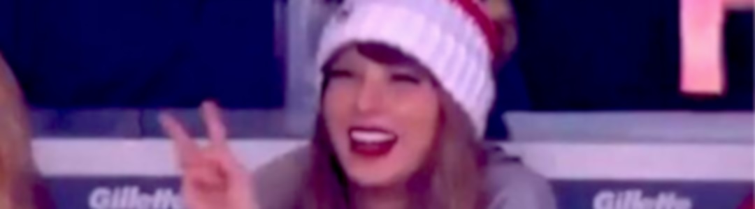 Taylor Swift flashes the peace sign at the Patriots–Chiefs game 2023
