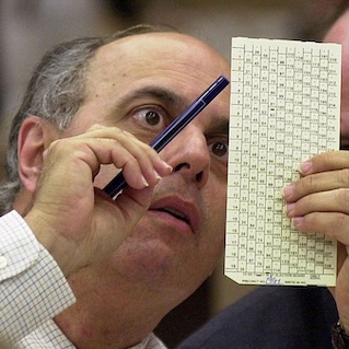 Man examining Florida ballot in 2000