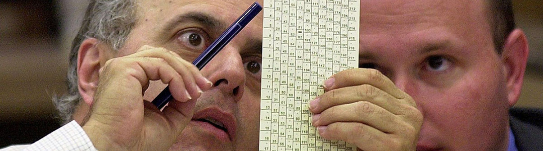 Two men examining Florida ballot in 2000